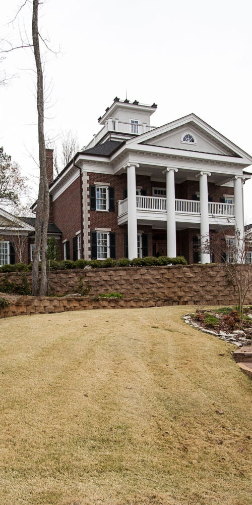 Terraced yard of Greek Revival styled home by Glenn Cope Custom Home Builders
