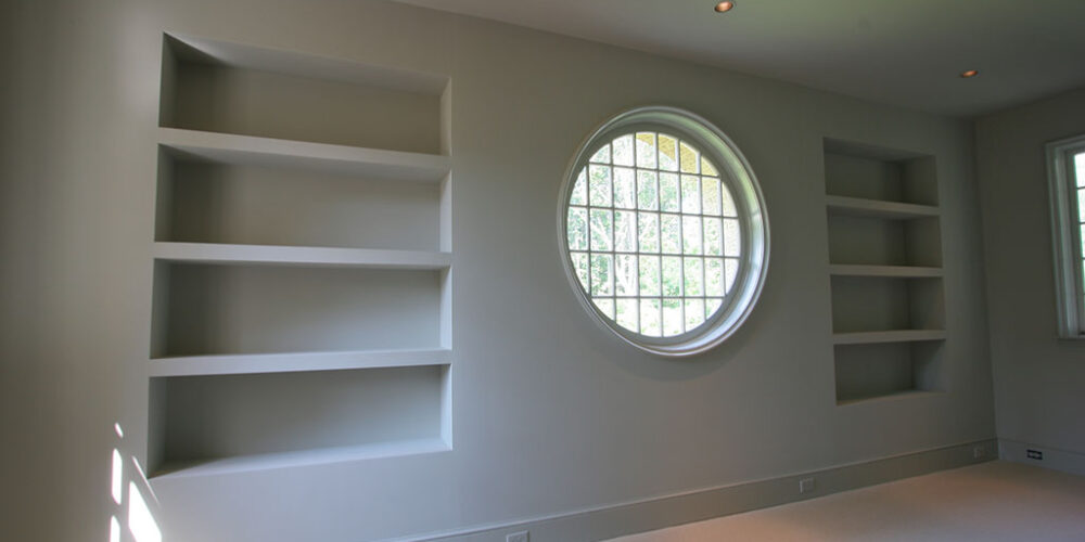 Large circle window in French cottage-style home by Glenn Cope Custom Homes