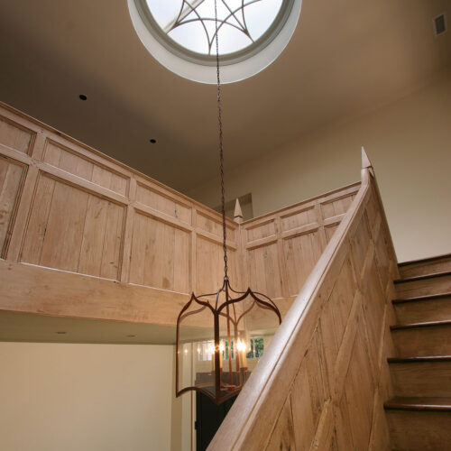 Intricately designed staircase and ceiling by Glenn Cope Custom Home Builders