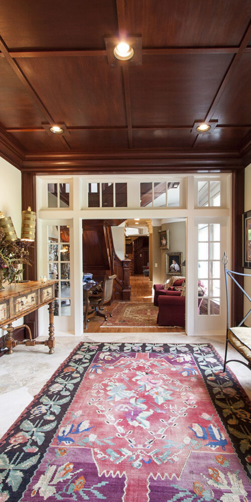 Intricate hallway with tie-in details Greek revival style custom home by Glenn Cope Custom Home Builders