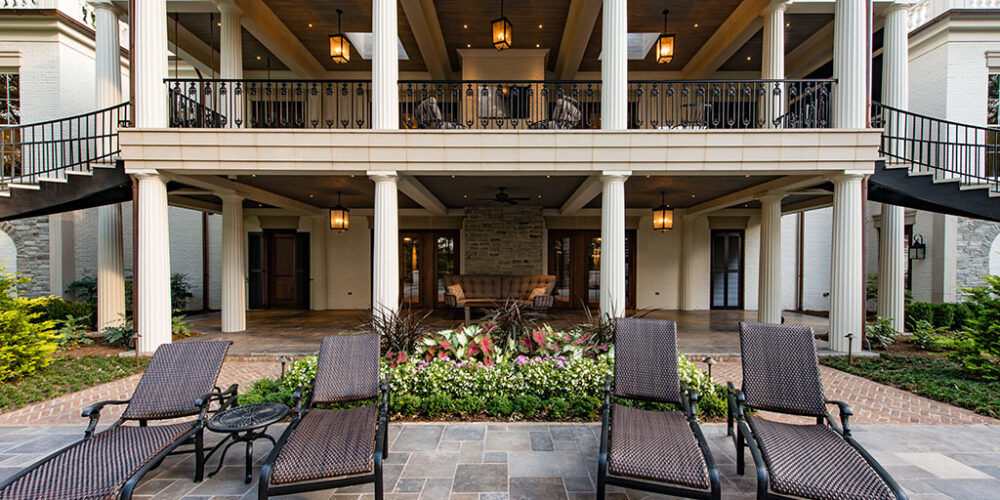 Patio and balcony terrace to Greek Revival styled home by Glenn Cope Custom Home Builders