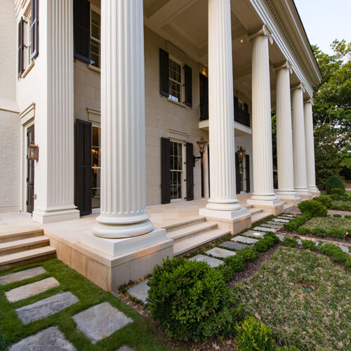 Front gardens and porch to Greek Revival styled home by Glenn Cope Custom Home Builders
