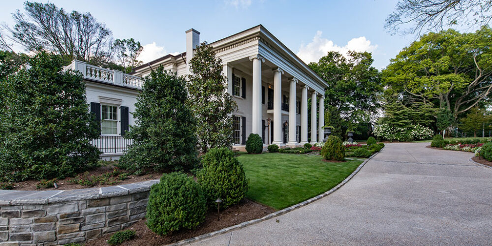Driveway leading to Greek Revival styled home by Glenn Cope Custom Home Builders